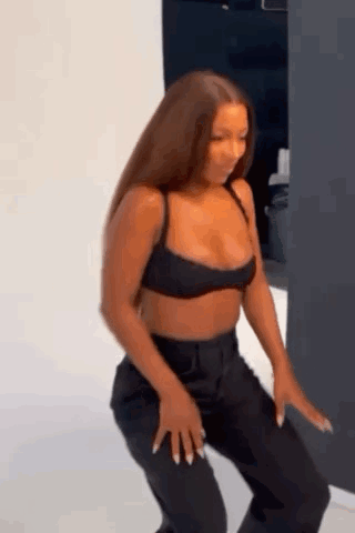 Woman in Crop Top and Black Pants Dancing
