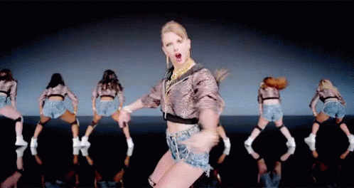 Woman in Crop Top and Shorts Dancing With Dancers