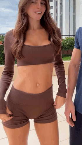Woman in Crop Top and Shorts Next to Man
