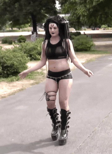 Woman in Crop Top and Shorts Walking
