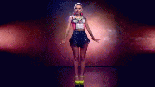 Woman in Crop Top and Skirt Dancing in Dark Room