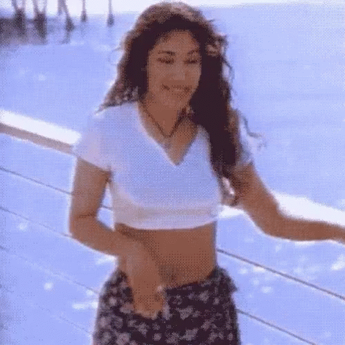 Woman in Crop Top Dancing on Balcony