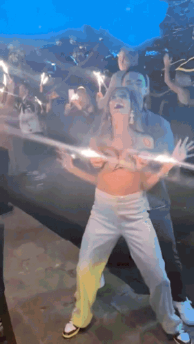 Woman in Crop Top Dancing With Sparklers