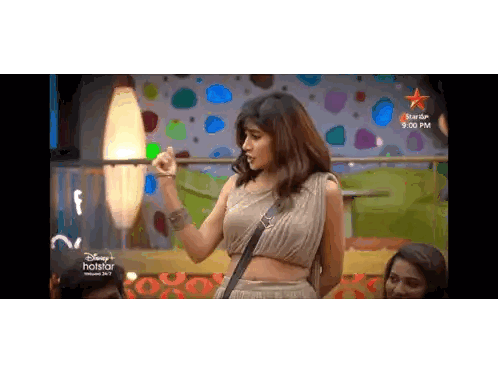 Woman in Crop Top in Front of Disney Hotstar Screen