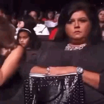 Woman in Crowd Arms Crossed Holding Purse