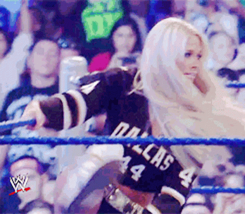 Woman in Dallas 44 Jersey Wrestling Ring Holding Rope