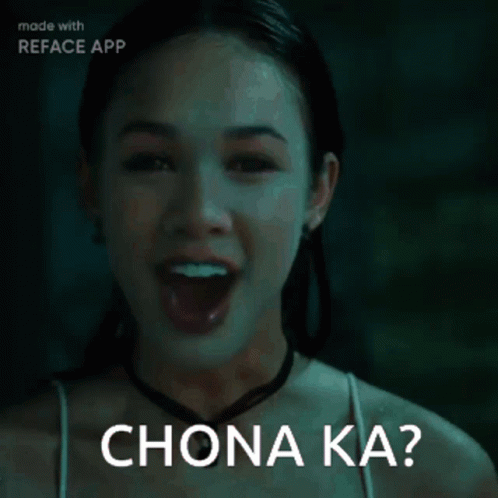 Woman in Dark Room Saying Chona Ka