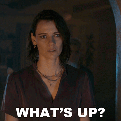 Woman in Dark Room Saying Whats Up