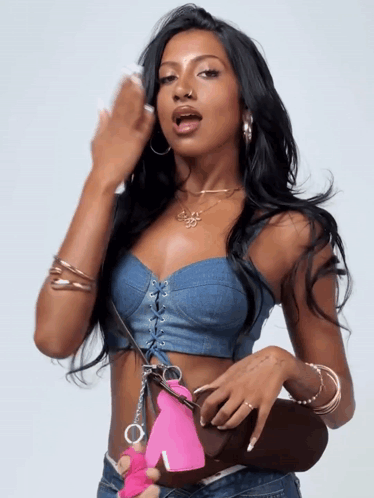 Woman in Denim Crop Top Holding Pink Handcuff
