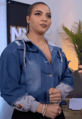 Woman in Denim Jacket at NY Sign