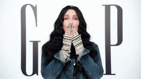 Woman In Denim Jacket Blowing A Kiss Gap Sign GIF