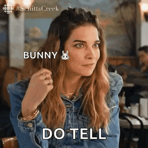 Woman in Denim Jacket Saying Do Tell