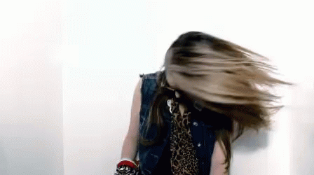 Woman In Denim Vest And Leopard Print Shirt Spinning Hair GIF