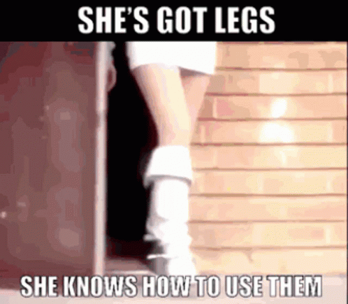 Woman In Doorway Wearing White Boots And Skirt GIF