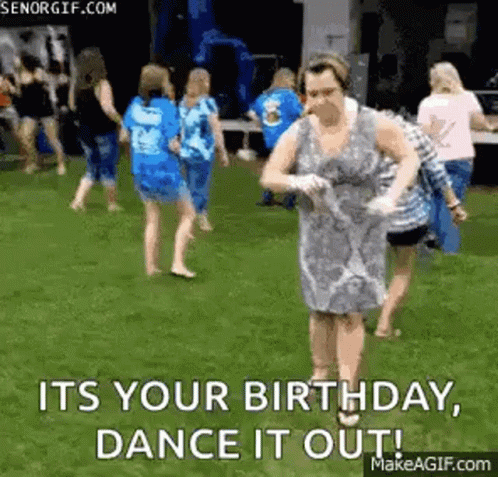 Woman In Dress Dancing In Field With Group GIF