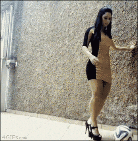 Woman In Dress Kicking Soccer Ball GIF