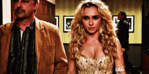 Woman In Dress Next To Man In Jacket GIF