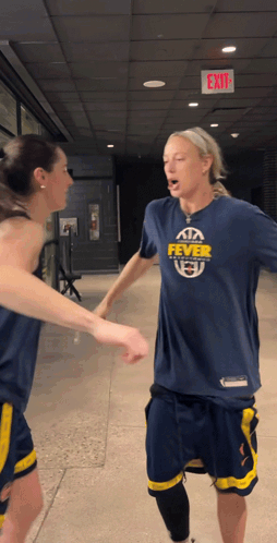Woman In Fever Shirt Shaking Hands GIF