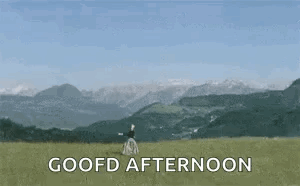 Woman In Field With Mountains Saying Goofd Afternoon GIF