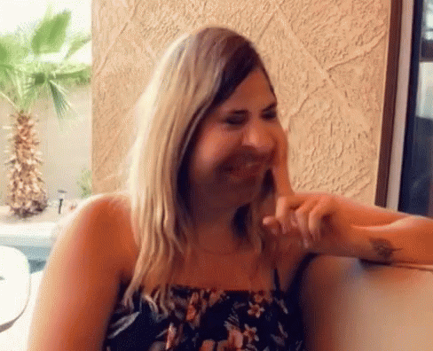 Woman In Floral Dress Laughing GIF