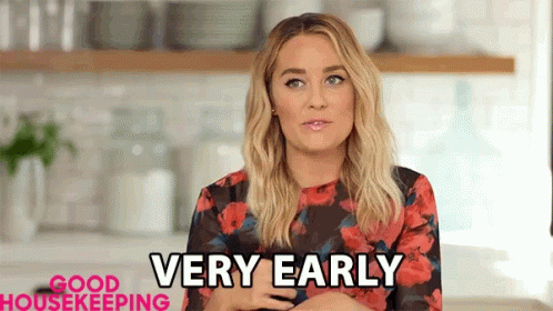 Woman In Floral Dress Saying Very Early GIF