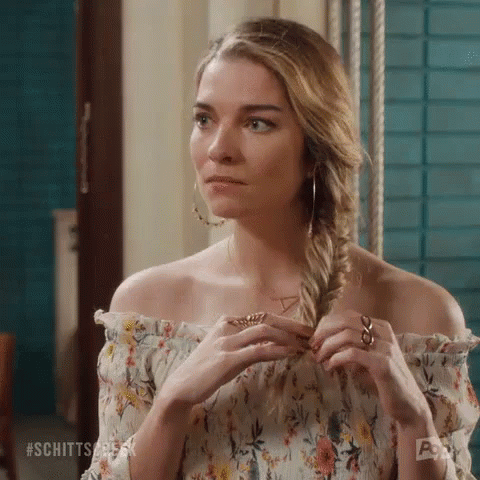 Woman In Floral Off-Shoulder Top Braiding Hair GIF