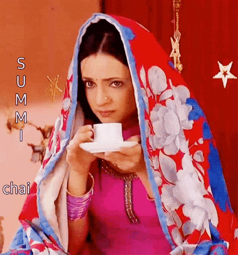 Woman In Floral Scarf Drinking Tea GIF