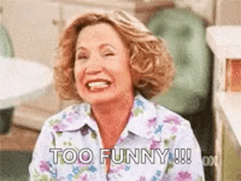 Woman in Floral Shirt Laughing Saying Too Funny