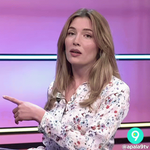 Woman in Floral Shirt Pointing Right