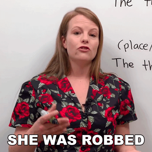 Woman in Floral Shirt Says She Was Robbed in Front of Whiteboard