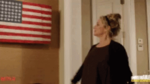 Woman In Front Of American Flag GIF