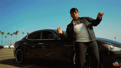 Woman in Front of Black Car with Number 24 on Sweatshirt