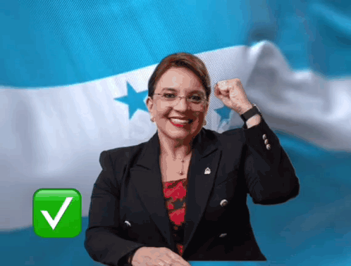Woman in Front of Blue and White Flag With Green Check Mark