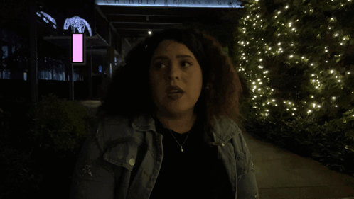 Woman in Front of Building Saying Move