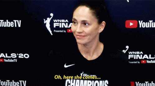 Woman In Front Of Champions Sign GIF