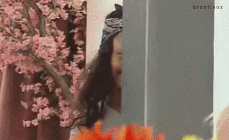 Woman In Front Of Cherry Blossom Tree Looking Out Window GIF
