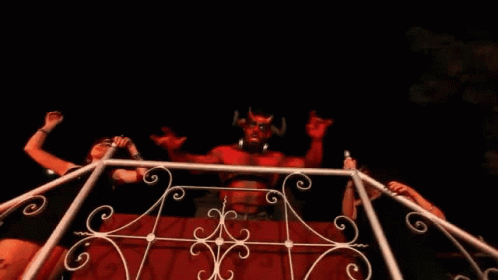 Woman in Front of Devil Statue with Horns
