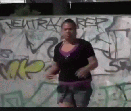 Woman In Front Of Graffiti Wall Saying Neutral Rep GIF