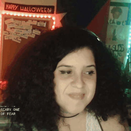 Woman in Front of Happy Halloween Sign