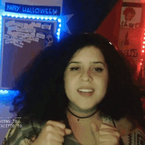 Woman in Front of Happy Halloween Sign