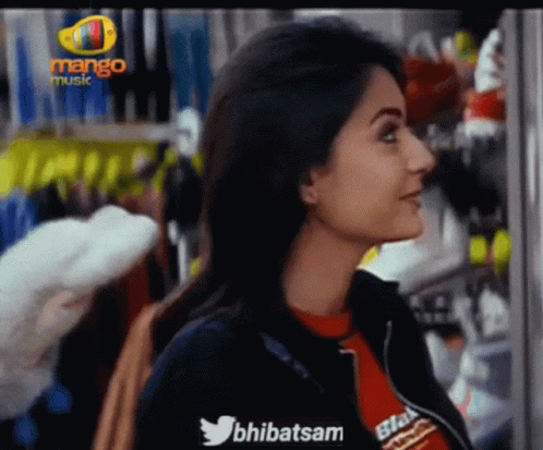 Woman In Front Of Mango Music Sign GIF