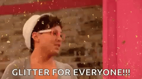 Woman in Front of Pink Wall Saying Glitter for Everyone