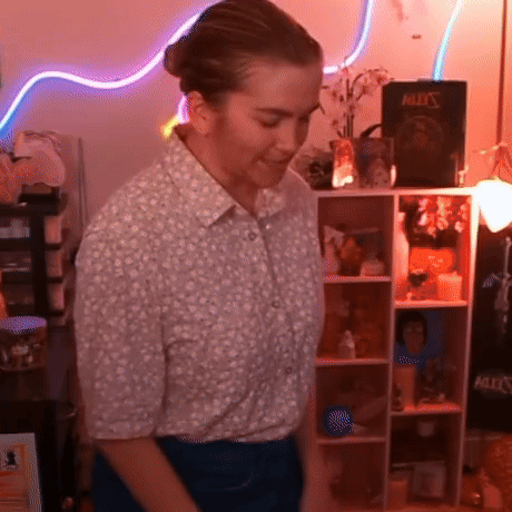 Woman in Front of Shelf With Book Bullet's