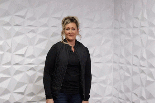 Woman In Front Of Wall Saying You Rock GIF