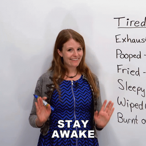 Woman in Front of White Board Saying Stay Awake