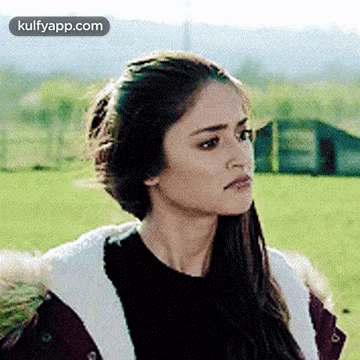 Woman in Fur Coat and Black Sweater in Field