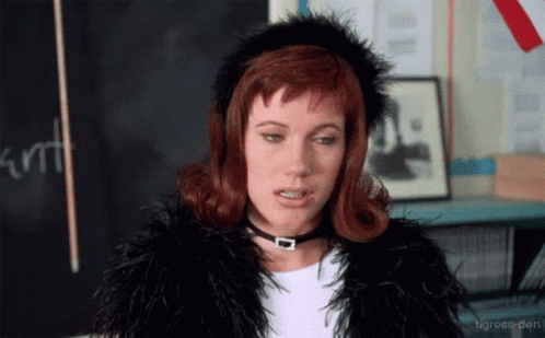 Woman in Fur Coat and Choker Blackboard Saying Kurt