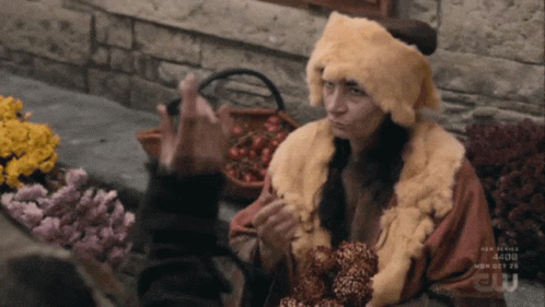 Woman in Fur Hat and Coat Talking to Another