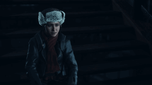 Woman In Fur Hat And Scarf Smiling In Dark GIF