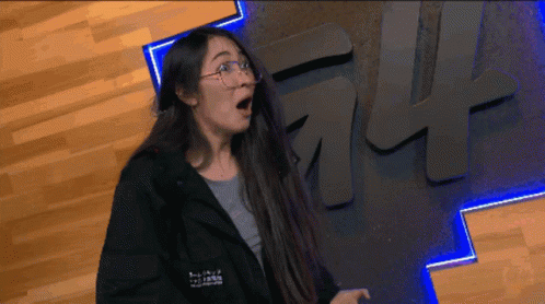Woman in Glasses and Black Jacket with ff Sign